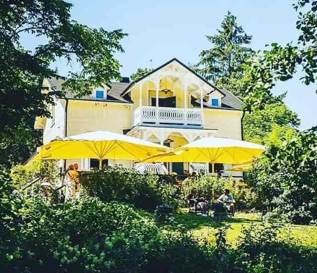 Charming outdoor venue with yellow umbrellas for events at Orangeriet, Bockholmen.