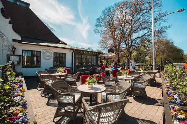 Beer garden at Wärdshuset Ulla Winbladh, vibrant flowers, ideal for casual events.