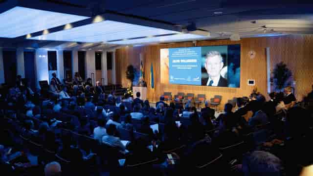 Wallenberg Auditorium conference with speaker, audience engagement, professional presentation.