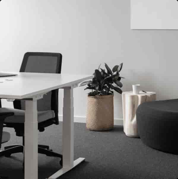 Modern private office with sleek white table, ideal for collaborative meetings and brainstorming.