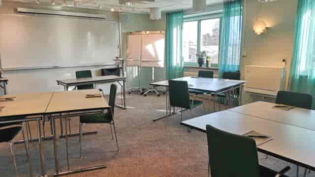 Banquet hall at Hotel Kristina, bright meeting room for workshops and discussions.