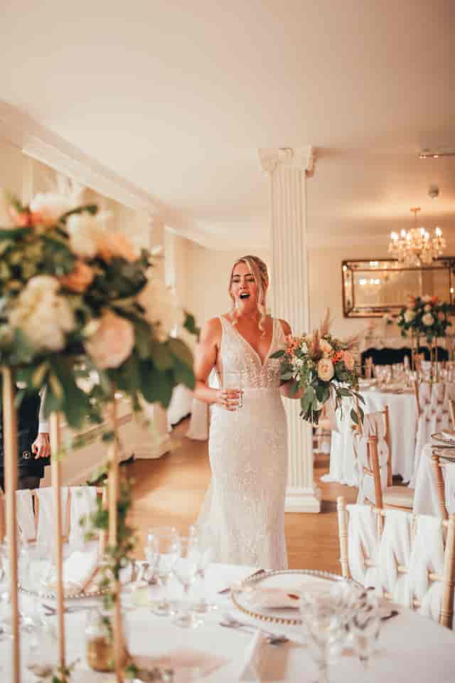 Elegant wedding reception in The Tabor Room, Parklands Quendon Hall with lush floral arrangements.