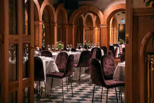 Elegant dining space at La Voûte, featuring wooden arches for upscale events.