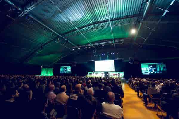 Victoriahallen conference venue with engaged audience and multiple screens for events.