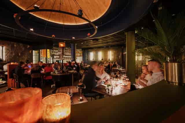 Vibrant restaurant in India with warm lighting, perfect for intimate gatherings and corporate dinners.