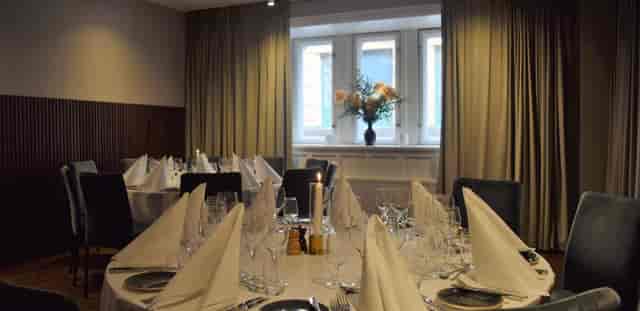 Elegant dining setup with white linens for corporate dinners and weddings.