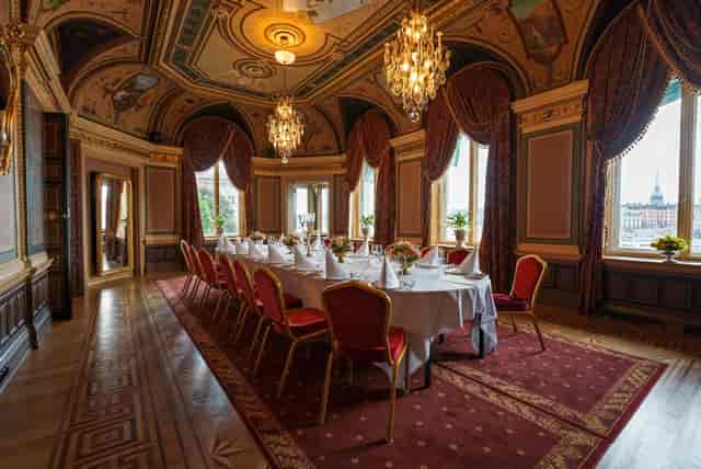 Elegant meeting room with ornate ceiling, ideal for corporate events and gatherings.