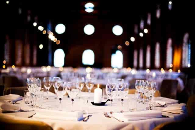 Elegant banquet hall dining setup with glassware, perfect for weddings and corporate events.