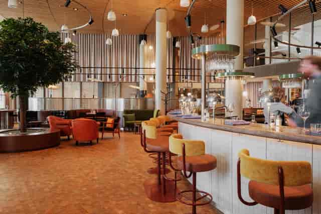 Modern event space in Hagastaden with stylish seating and warm lighting.