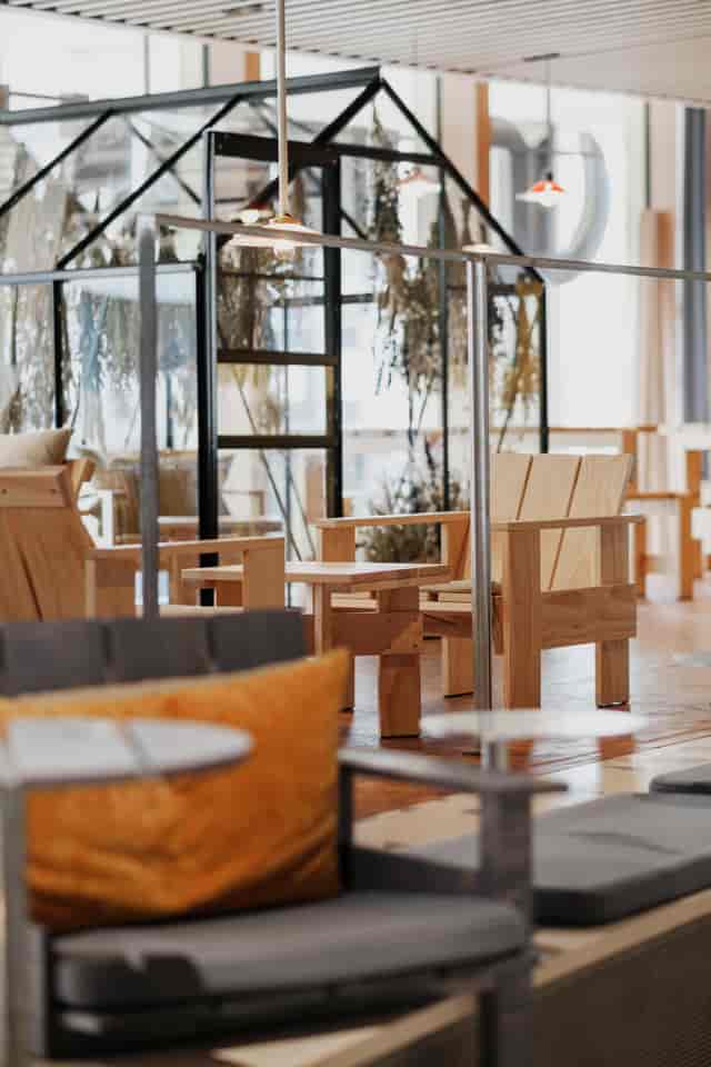 Modern seating area in Hagastaden, featuring wooden chairs for networking events.