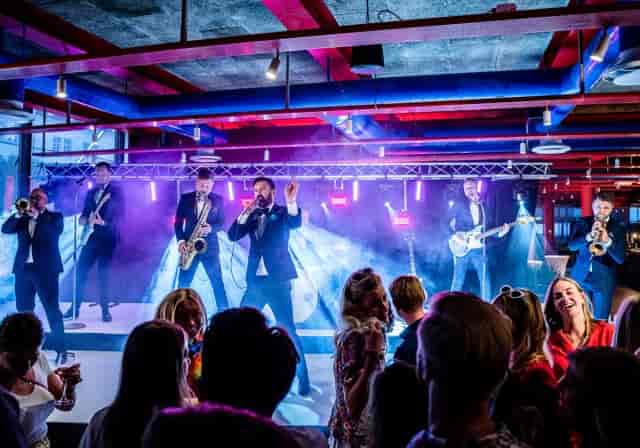 Live band performing at Café in Garnisonen, vibrant atmosphere for events and entertainment.