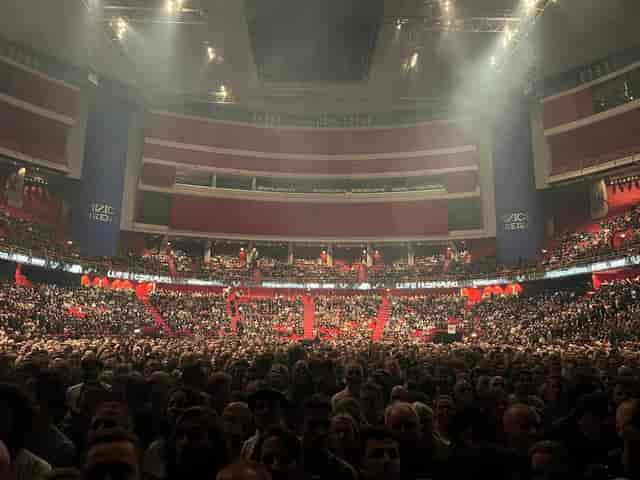 Packed Avicii Arena concert hall with enthusiastic crowd, showcasing event planning excellence.