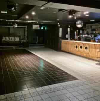 Private Hire event space in Wilson's Den with bar and jukebox for gatherings.