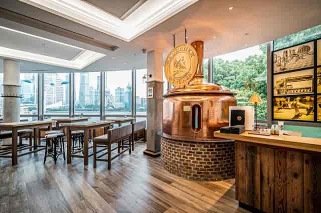 Stylish Paulaner Wirtshaus Shanghai with copper brewing kettle, perfect for networking events.