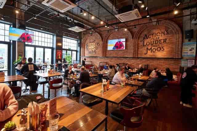 Vibrant Fat Cow restaurant with brick walls, ideal for casual meetings and events.