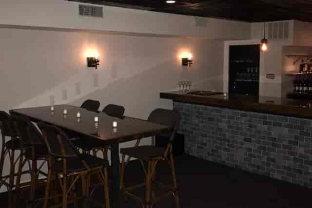Main Floor Long Oak Bar in Shanghai Jazz, sleek bar, cozy event space for gatherings.