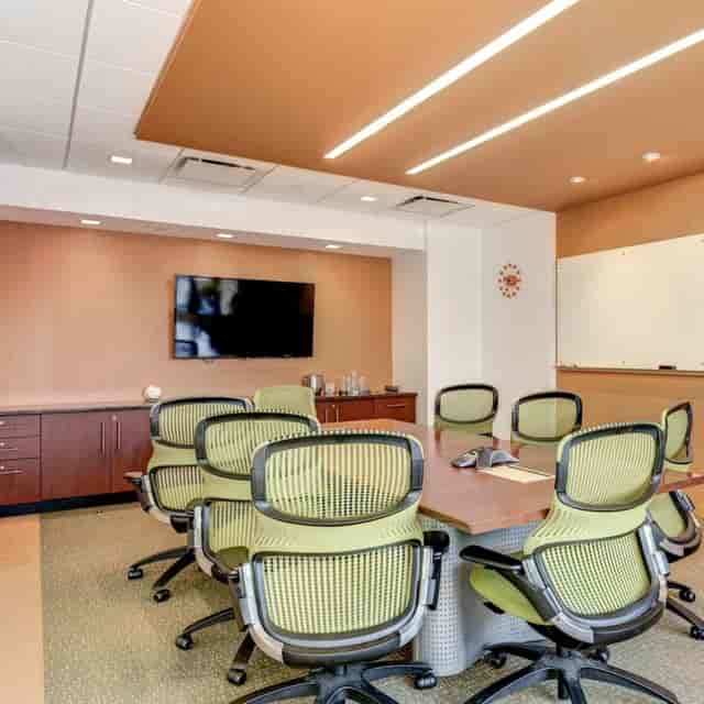 Modern conference room with sleek table, ideal for legal meetings and presentations.
