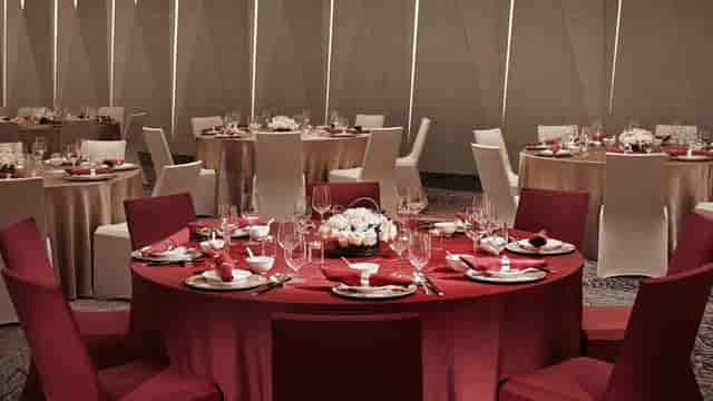 Grand Ballroom at Shanghai Marriott with elegant red tables for corporate events.