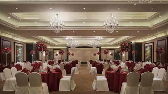 Elegant banquet hall with chandeliers, perfect for weddings and corporate events.