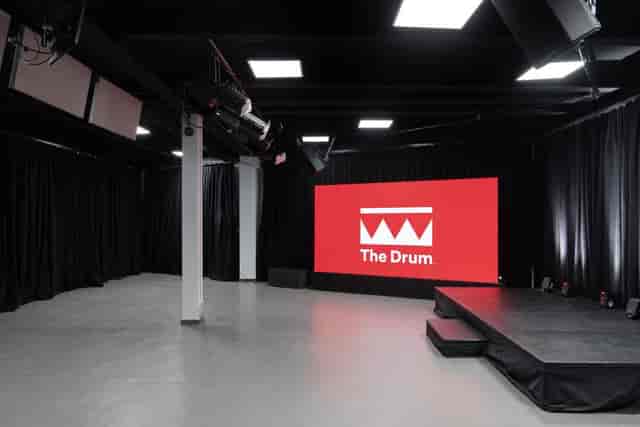 Modern event space with digital screen, ideal for presentations and performances.
