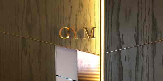 Penthouse Gym entrance at Tower Club Singapore, elegant wood paneling for corporate wellness events.
