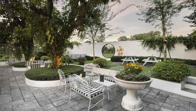 Outdoor event venue at The White Rabbit with lush greenery and elegant decor.