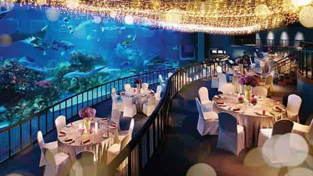 Elegant conference room with aquarium backdrop for upscale corporate events.