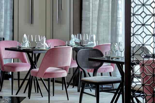 Stylish dining space with pink chairs for corporate events at Tablescape Restaurant, Grand Park.