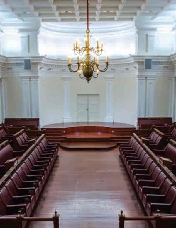 Elegant meeting room with raised stage, ideal for conferences and formal events.