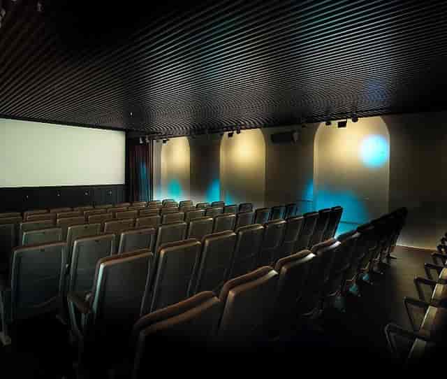 Modern auditorium with tiered seating for corporate events and film screenings.