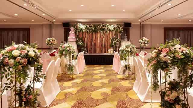 Atrium Ballroom at Holiday Inn Singapore, elegant wedding venue with floral decor.