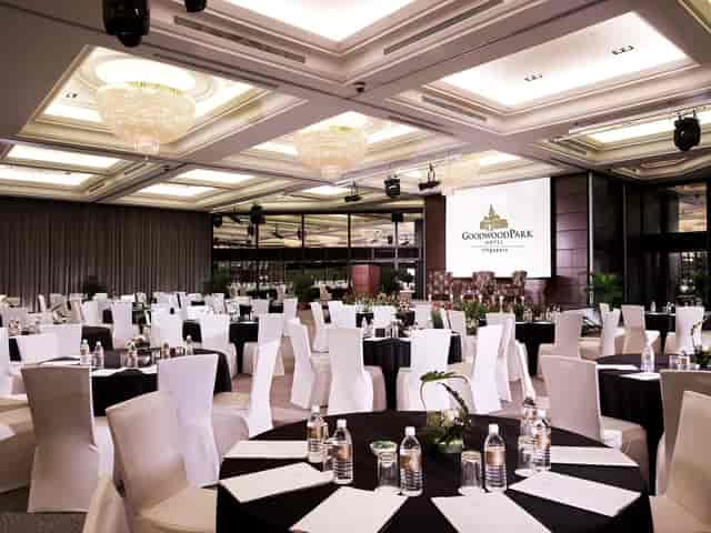 Ballroom at Goodwood Park Hotel, elegantly set for corporate events with modern chandeliers.