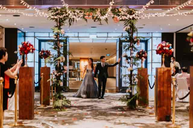 Grand Ballroom wedding entrance with floral decor and soft lighting at Singapore Marriott.