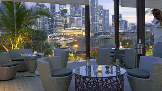 Outdoor lounge at Mandarin Oriental, Singapore with skyline view for networking events.
