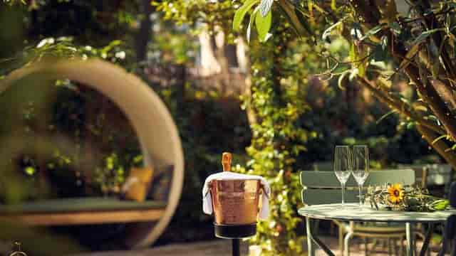 Outdoor event space at Park Plaza Vondelpark with elegant champagne setup and greenery.