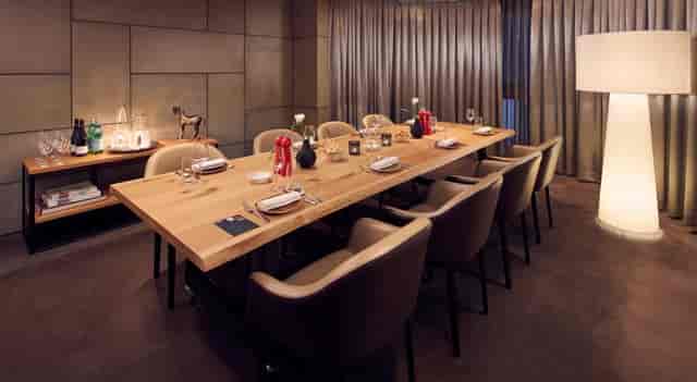 Private dining room at art'otel Amsterdam, elegant setup for intimate events and meetings.