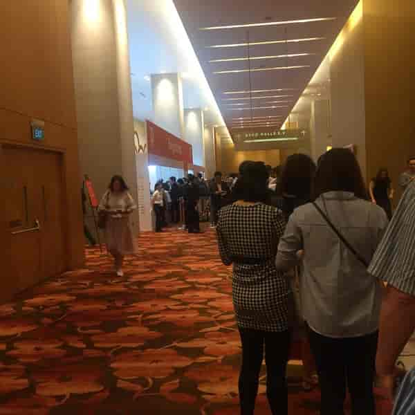 "Busy event registration at Sands Expo, showcasing modern decor and efficient check-in."