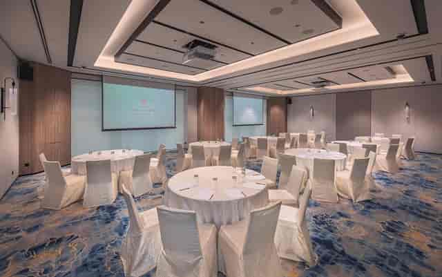 Conference room with round tables, ideal for networking events and workshops.