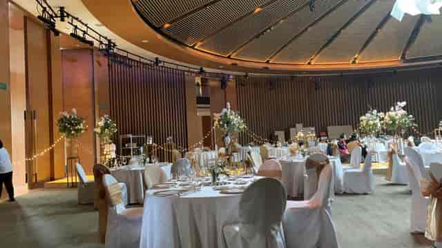 Grand Ballroom at Capella Singapore, elegant wedding venue with floral decor and soft lighting.