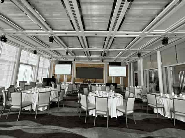 Conference center in Conrad Centennial Singapore with elegant round tables for corporate events.