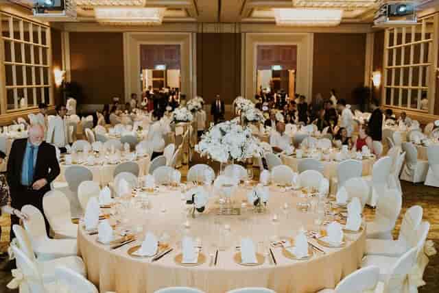 Elegant banquet hall with floral centerpieces for formal events in Conrad Centennial Singapore.