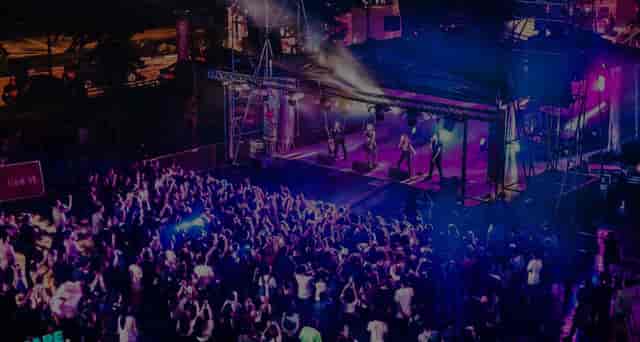 Vibrant outdoor concert at *SCAPE with a large crowd enjoying live music.