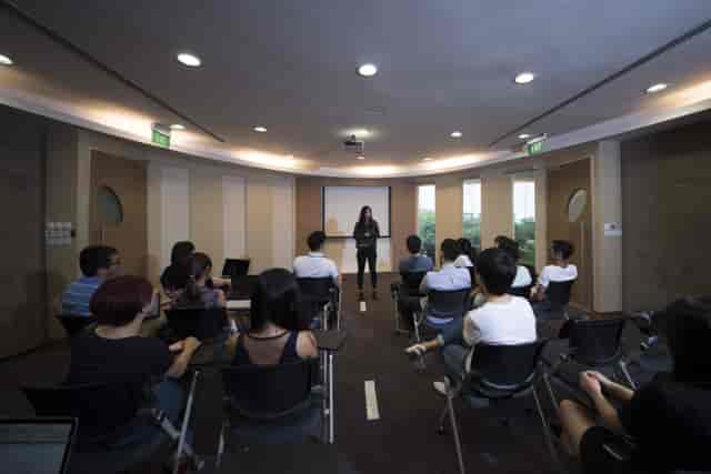 Event Space in *SCAPE with presenter, natural light, ideal for meetings and collaboration.