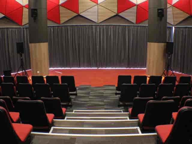 Main Hall in *SCAPE with tiered seating, ideal for presentations and workshops.