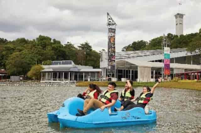 Group on paddle boat at Discovery Land, Singapore, enjoying team-building event.