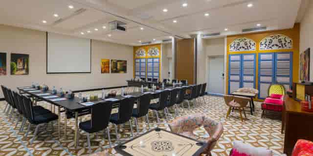 Joo Chiat Room at Hotel Indigo Singapore, modern meeting space with vibrant decor.