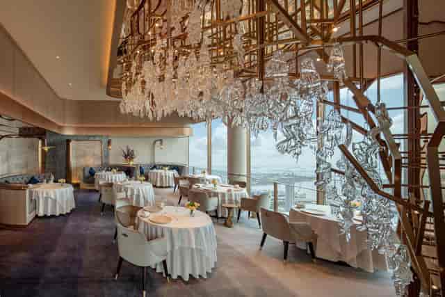 Elegant banquet hall with chandelier, perfect for corporate events and intimate gatherings.