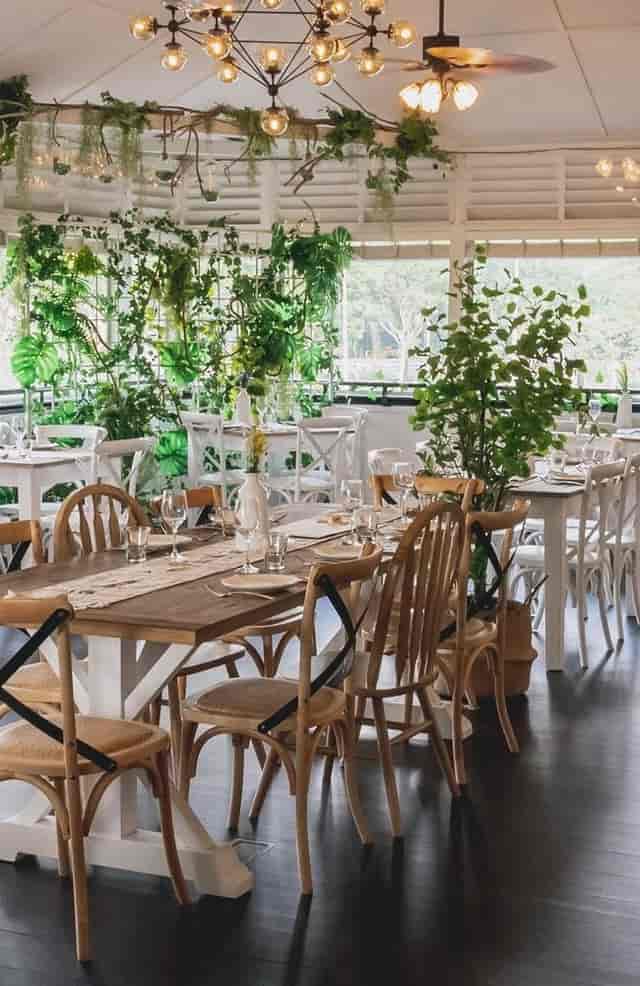Elegant dining hall with greenery, perfect for intimate gatherings and corporate events.