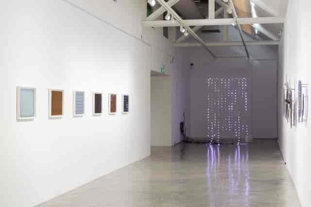 Modern gallery space with framed artworks, ideal for art exhibitions and corporate events.