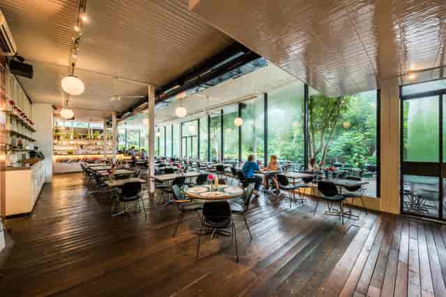 Modern PS.Cafe venue with large windows, perfect for meetings and events.